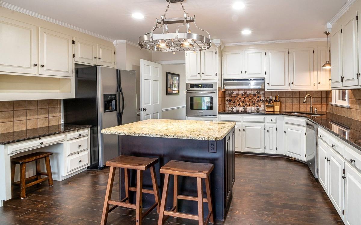 Kitchen with dark wood-effect plank flooring and an island